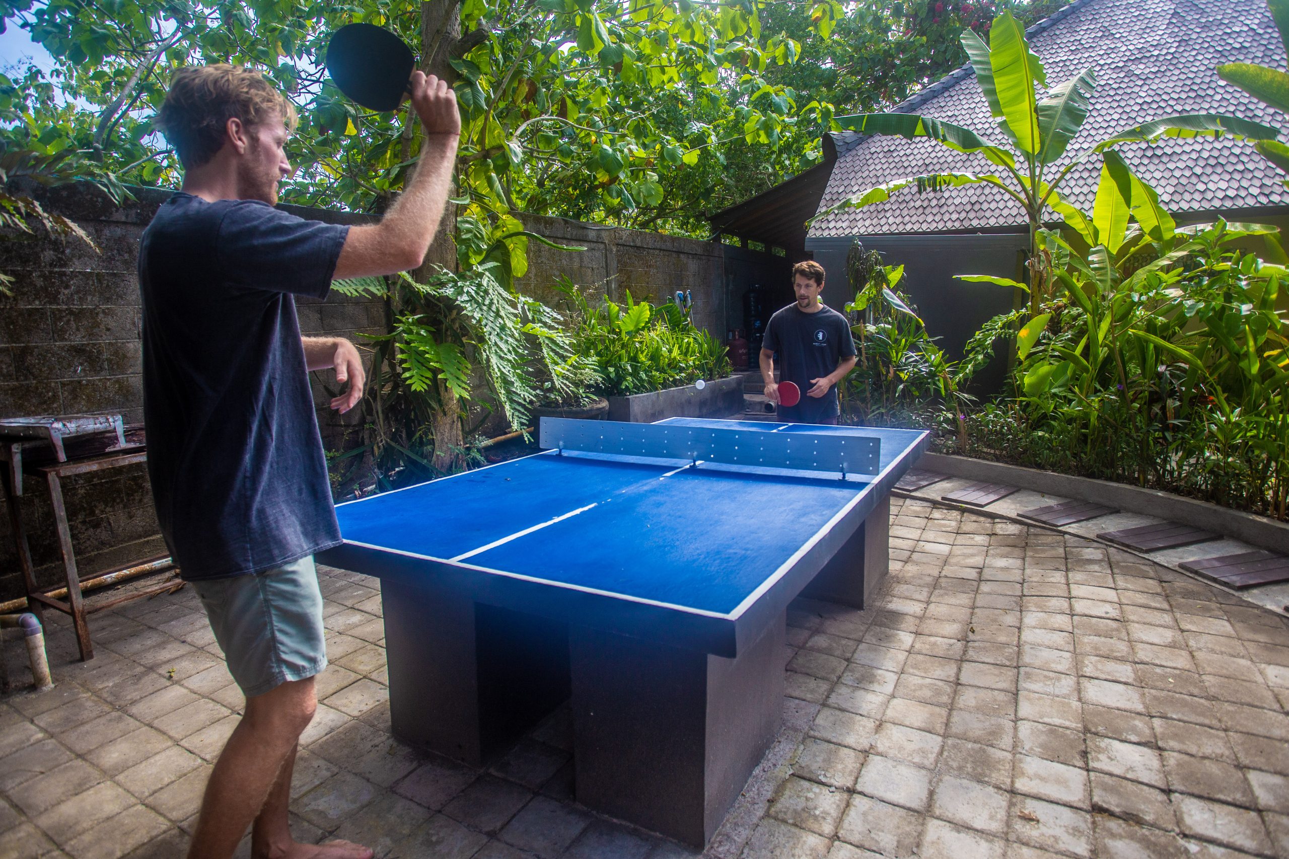 Two people playing ping pong.