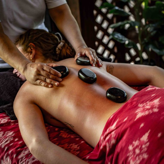 A guest enjoying a Balinese Hot Stone Massage.