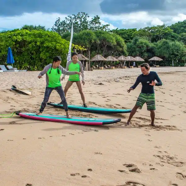 Instructor Scotty explaining the basics of surfing on the beach.